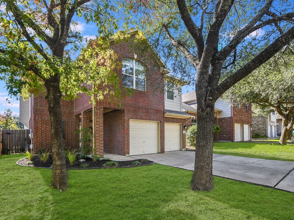 a tree in front of a white house