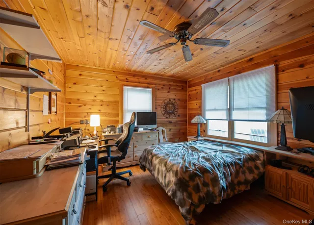 a bed room with furniture and a large window