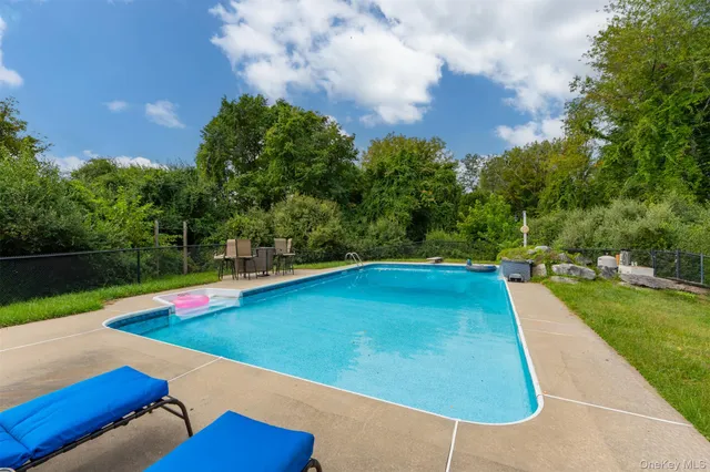 a view of swimming pool with lounge chair