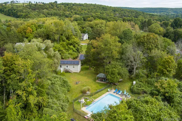 an aerial view of a house with a yard