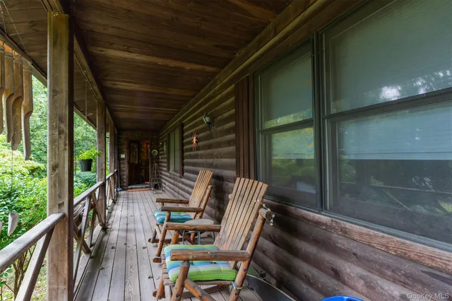 a view of deck with chairs and wooden floor