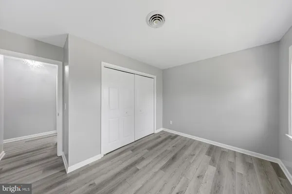 a view of room with wooden floor