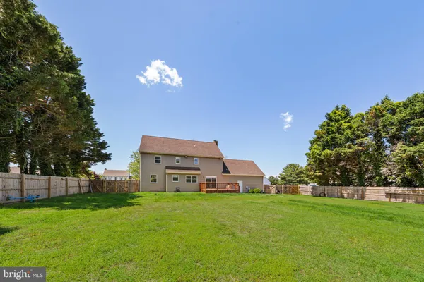 a aerial view of a house with garden space and trees