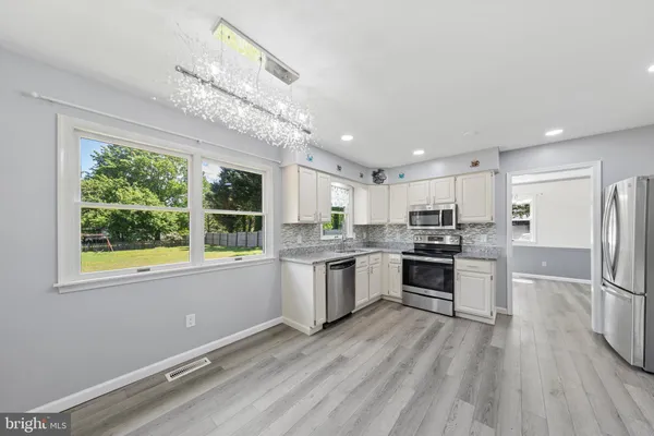 a kitchen with a refrigerator a stove top oven and kitchen island