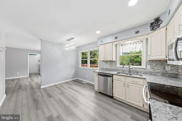 a kitchen with a sink cabinets and window