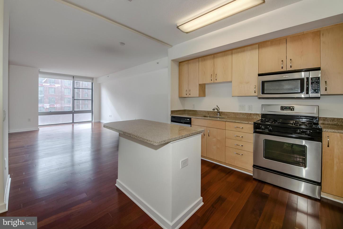 475 K Street Northwest, Unit 720 Washington, DC 20001 - Photo 1 of 23 a kitchen with a stove a sink and a microwave