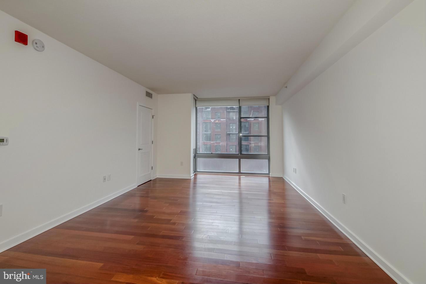 475 K Street Northwest, Unit 720 Washington, DC 20001 - Photo 3 of 23 a view of an empty room with wooden floor and closet