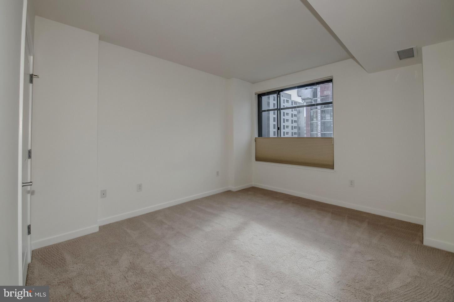 475 K Street Northwest, Unit 720 Washington, DC 20001 - Photo 6 of 23 an empty room with a window