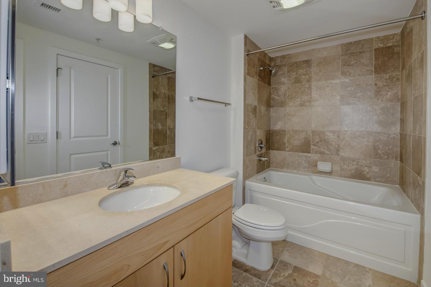 475 K Street Northwest, Unit 720 Washington, DC 20001 - Photo 7 of 23 a bathroom with a granite countertop sink toilet and shower