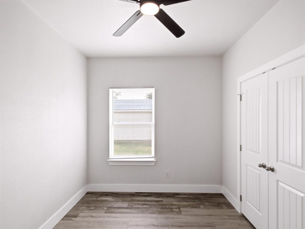 105 Oak Ridge Road Mabank, TX 75156 - Photo 23 of 34 Wood-finish flooring, white walls, and a window with blinds