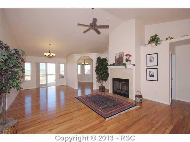 15028 Herring Road Colorado Springs, CO 80908 - Photo 3 of 17 Great room to the formal dining area with walk-out to the wrap around deck.