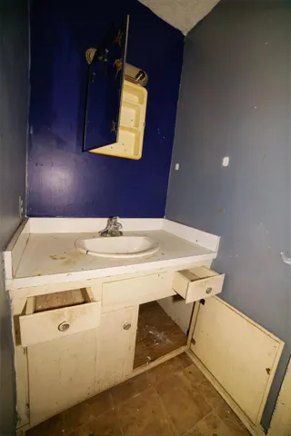 a kitchen with kitchen island granite countertop a sink and refrigerator