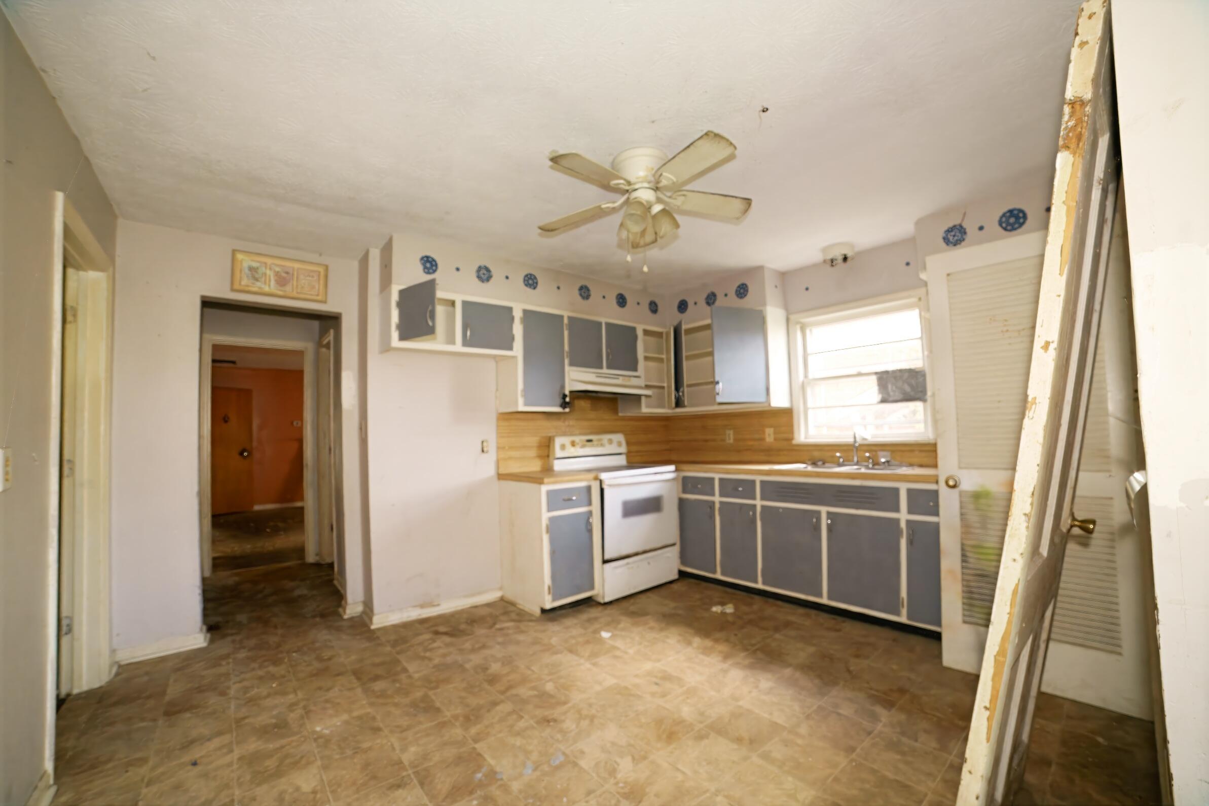 332 East Prospect Street Covington, VA 24426 - Photo 20 of 54 a kitchen with kitchen island granite countertop a sink and refrigerator
