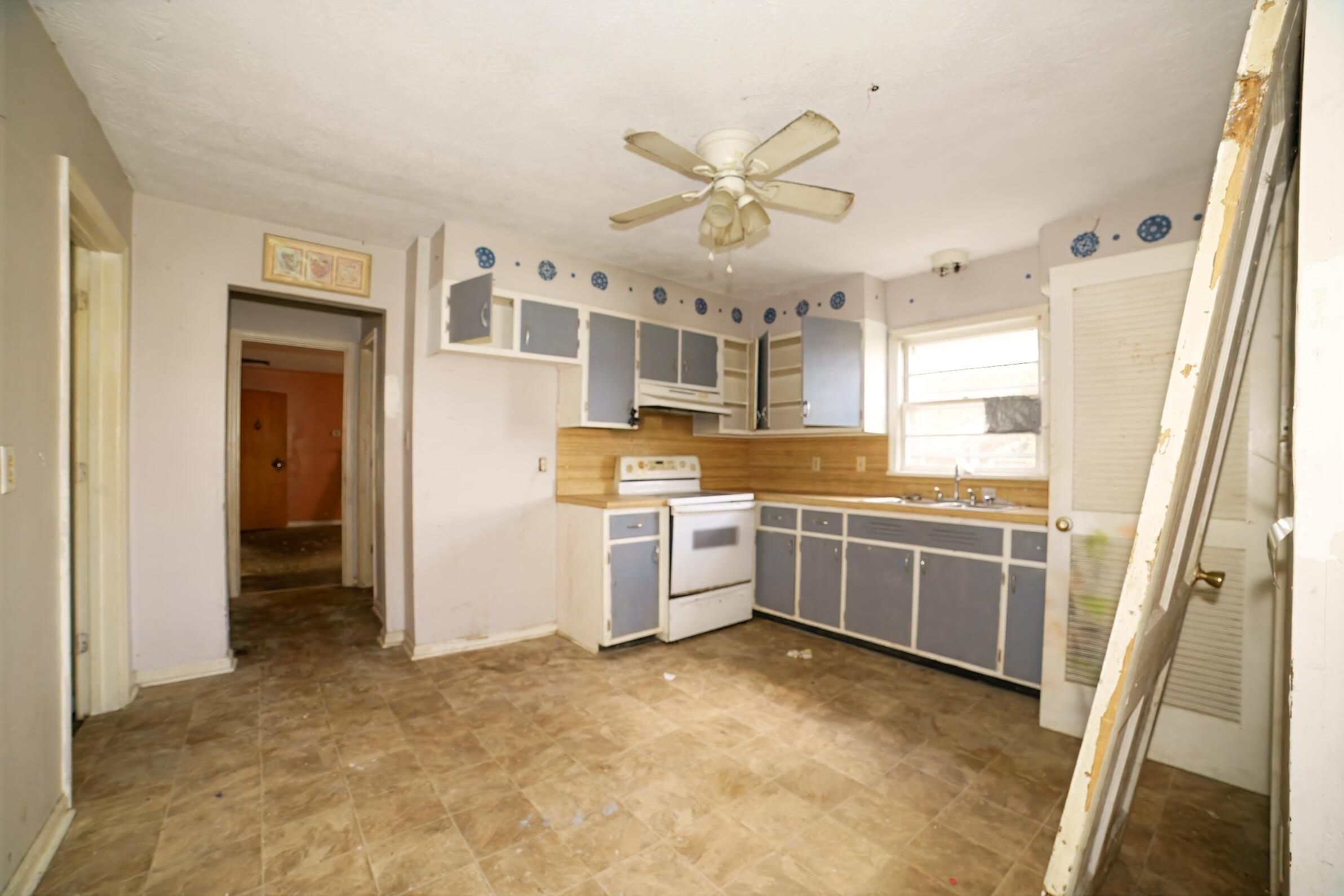 332 East Prospect Street Covington, VA 24426 - Photo 21 of 54 a large white kitchen with a stove top oven and sink