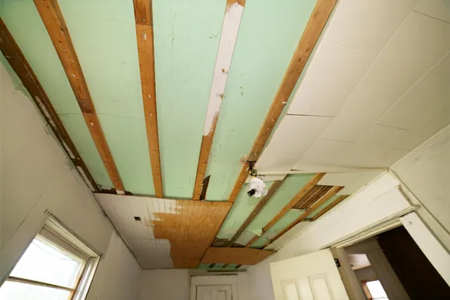 a living room with a stove and a refrigerator