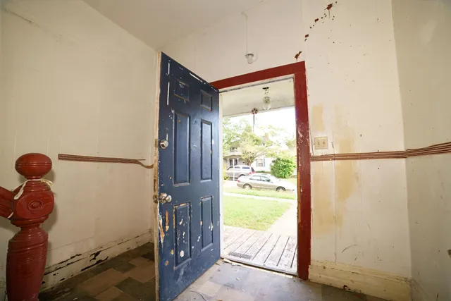 a view of entryway and hall with wooden floor