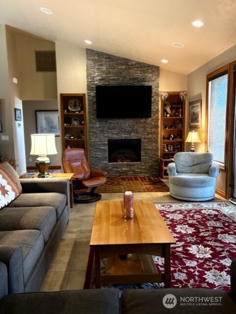 4062 Knowles Road Wenatchee, WA 98801 - Photo 5 of 20 a living room with furniture a flat screen tv and a fireplace