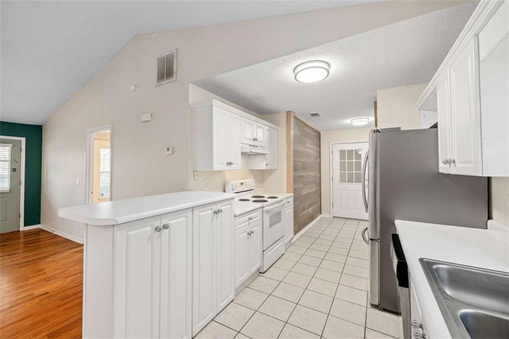 226 Chestnut Avenue Demorest, GA 30535 - Photo 11 of 47 a kitchen with white cabinets appliances and a sink