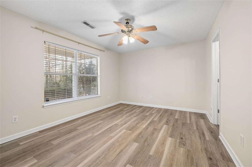 226 Chestnut Avenue Demorest, GA 30535 - Photo 15 of 47 wooden floor in an empty room with a window