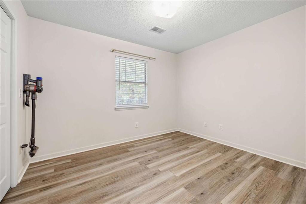 226 Chestnut Avenue Demorest, GA 30535 - Photo 23 of 47 a view of empty room with wooden floor and fan