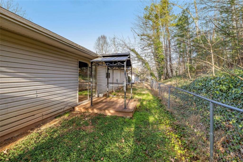 226 Chestnut Avenue Demorest, GA 30535 - Photo 32 of 47 a backyard of a house with table and chairs and wooden fence