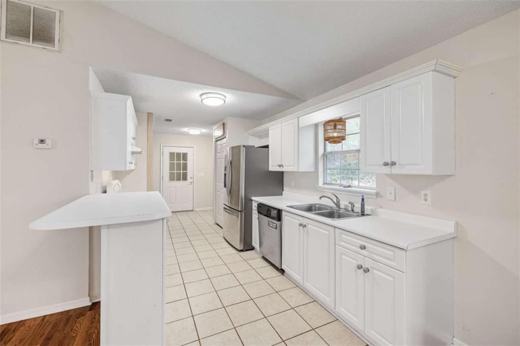 226 Chestnut Avenue Demorest, GA 30535 - Photo 10 of 47 a kitchen with a sink a stove a refrigerator and white cabinets
