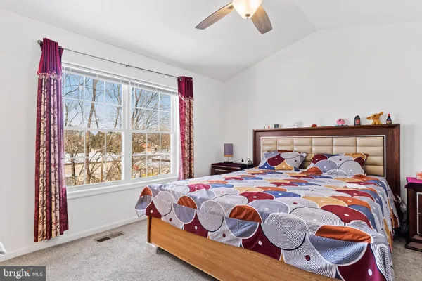 a bedroom with a bed and window