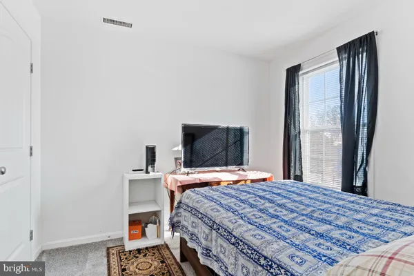 a bedroom with a bed and a television