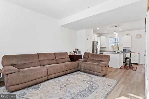 a living room with furniture and kitchen view