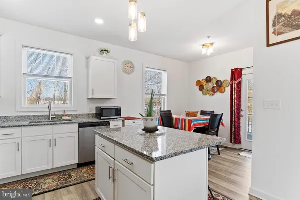 a kitchen with a stove a sink and a refrigerator