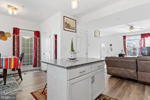 a living room with granite countertop furniture and a wooden floor