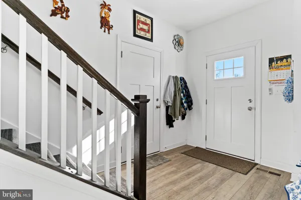 a view of entryway with wooden floor and stairs