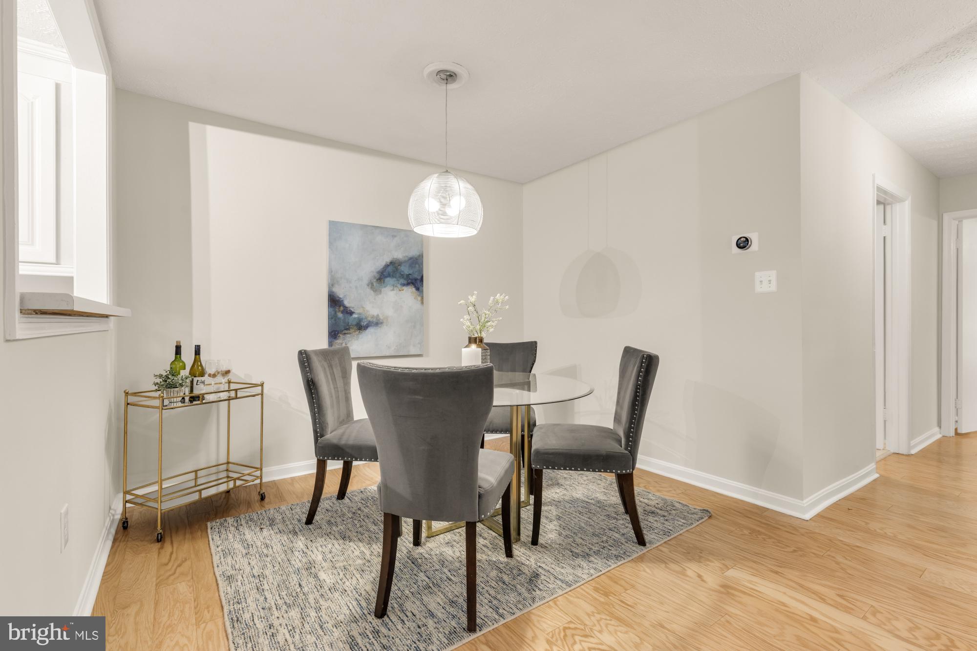 45 Windbrooke Circle, Unit 45 Gaithersburg, MD 20879 - Photo 14 of 29 a dining room with furniture a rug and wooden floor