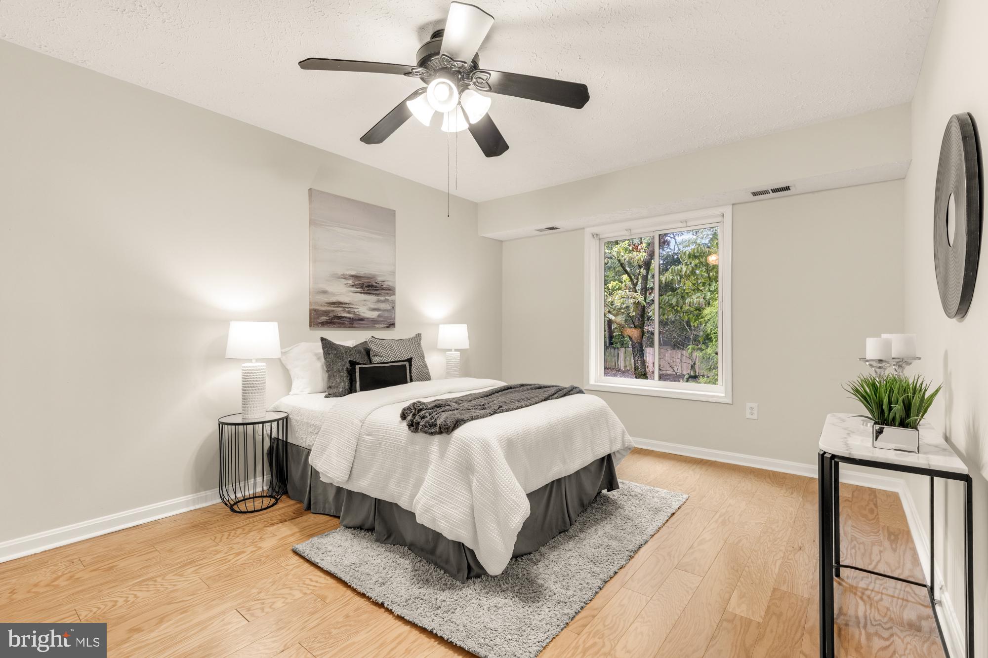 45 Windbrooke Circle, Unit 45 Gaithersburg, MD 20879 - Photo 19 of 29 a bed room with a bed and a chandelier