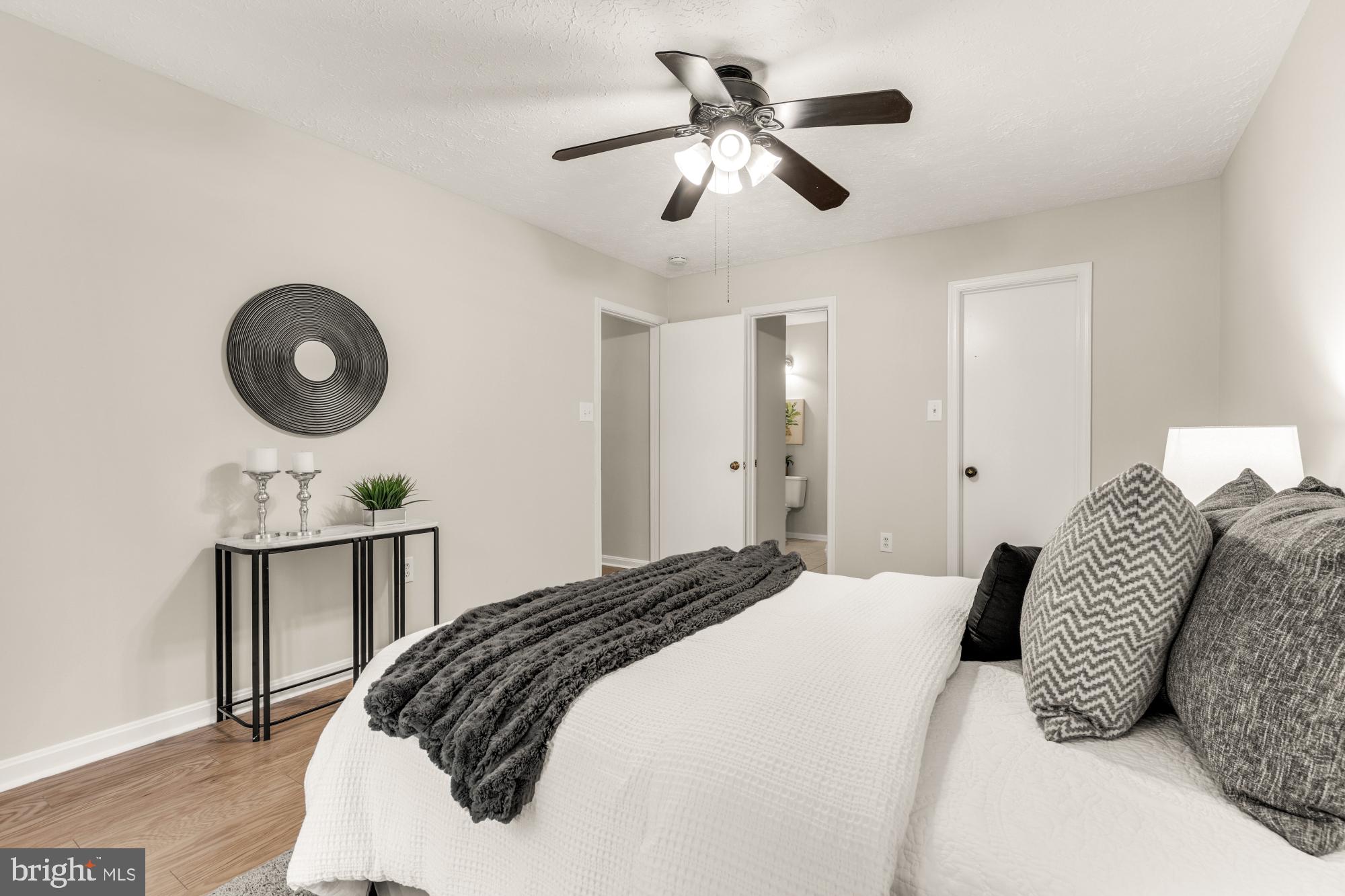 45 Windbrooke Circle, Unit 45 Gaithersburg, MD 20879 - Photo 21 of 29 a bedroom with a bed and a chandelier