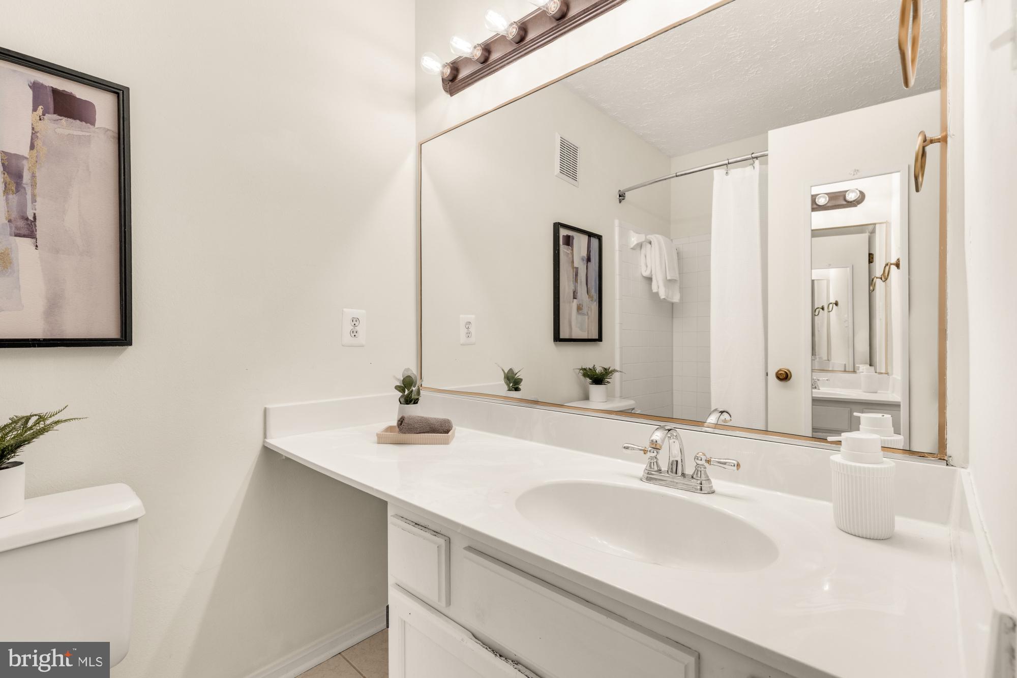 45 Windbrooke Circle, Unit 45 Gaithersburg, MD 20879 - Photo 26 of 29 a bathroom with a sink and a mirror