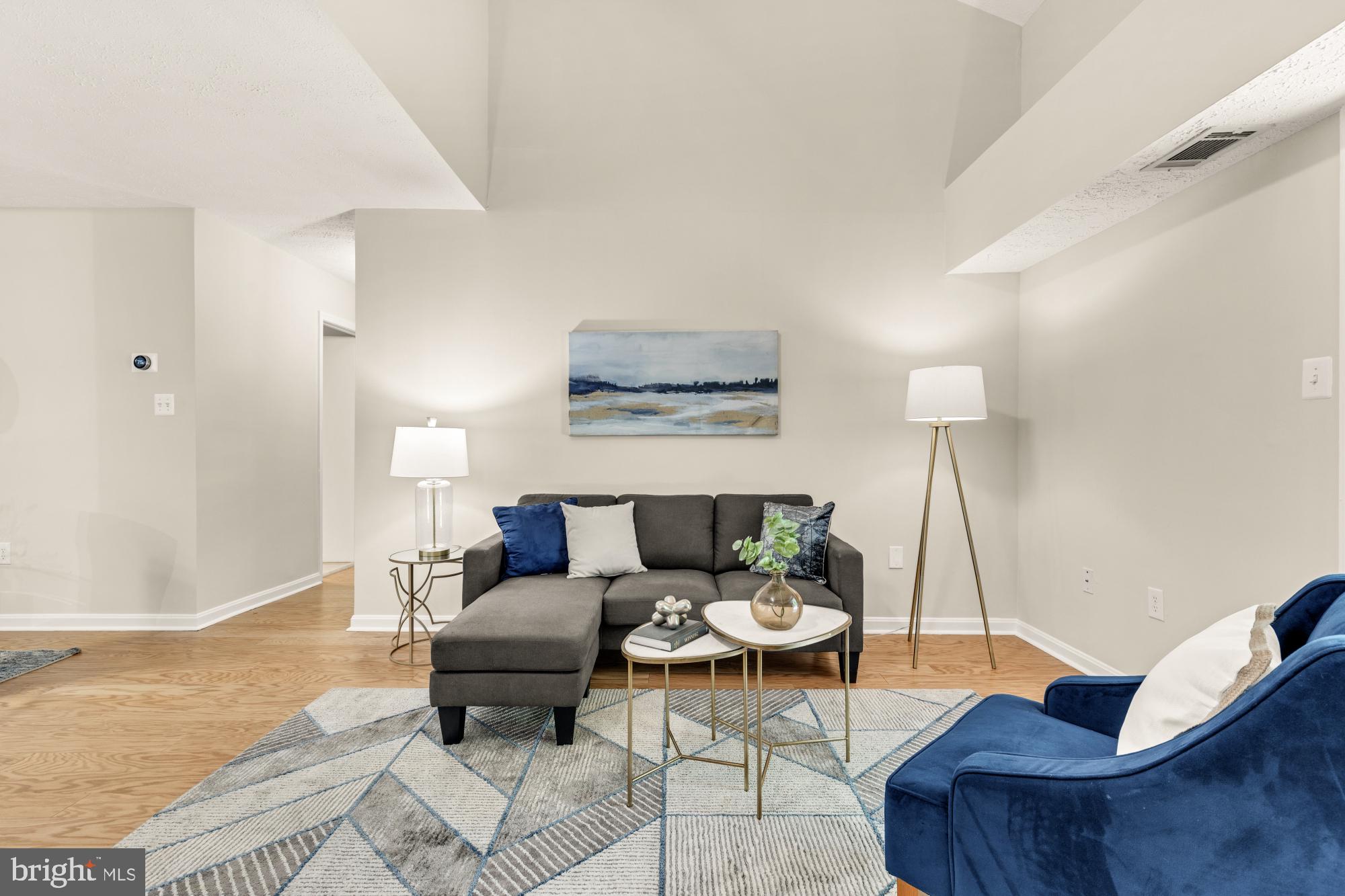 45 Windbrooke Circle, Unit 45 Gaithersburg, MD 20879 - Photo 10 of 29 a living room with furniture and a table