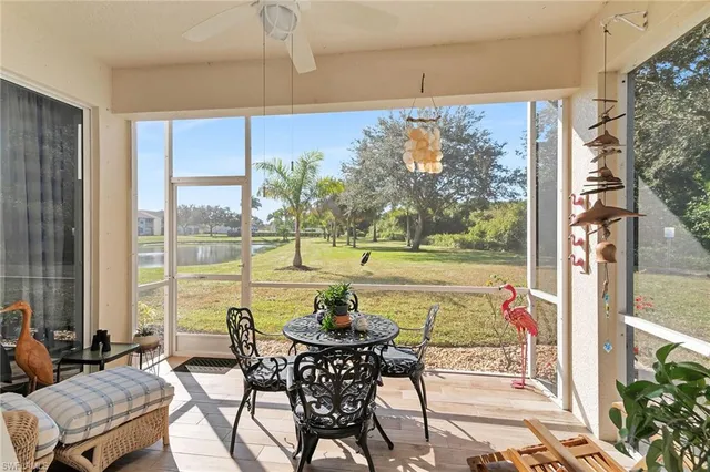 a view of a lake with a yard and palm trees