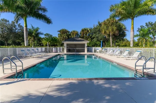 an aerial view of a residential houses with outdoor space and swimming pool