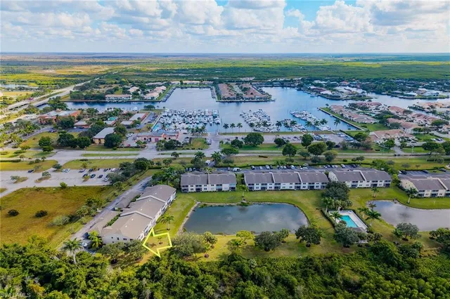 an aerial view of residential houses with outdoor space and lake view