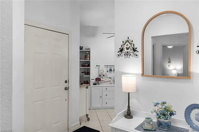 a kitchen with stainless steel appliances granite countertop a refrigerator stove a sink and white cabinets