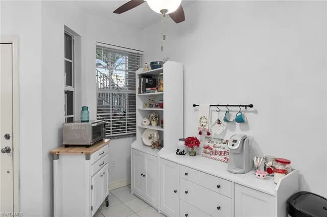 a kitchen with granite countertop white cabinets and a sink
