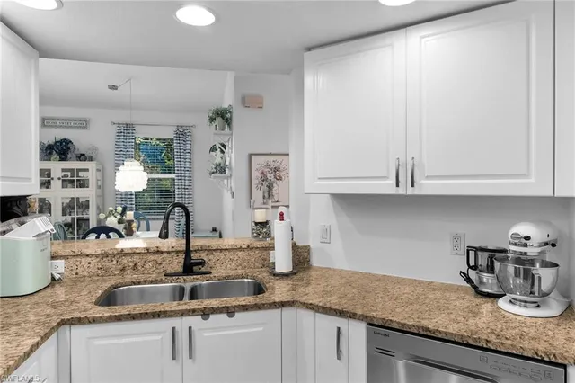 a living room with furniture a flat screen tv and a large window