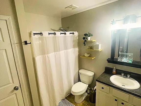 837 Forrest Circle Southeast Atlanta, GA 30354 - Photo 14 of 17 a bathroom with a granite countertop sink toilet a mirror a vanity and a shower