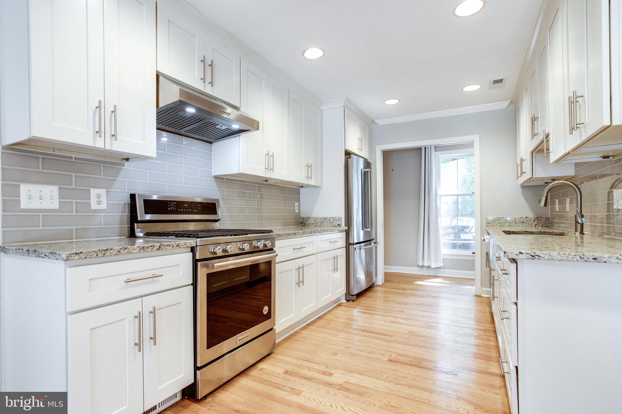 8500 Brook Road McLean, VA 22102 - Photo 15 of 59 a kitchen with stainless steel appliances granite countertop a stove sink and cabinets
