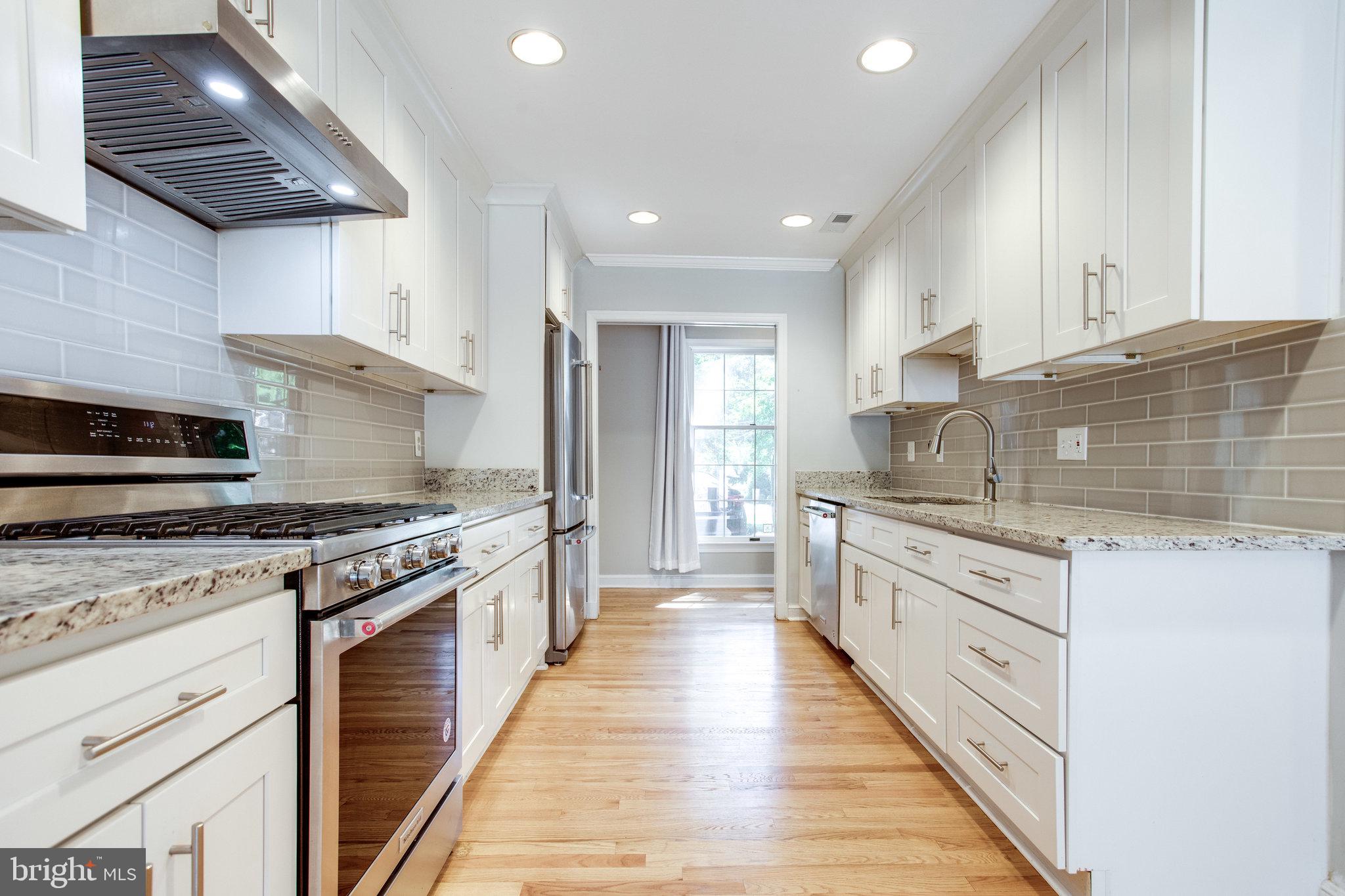 8500 Brook Road McLean, VA 22102 - Photo 16 of 59 a large kitchen with stainless steel appliances granite countertop a stove and a sink