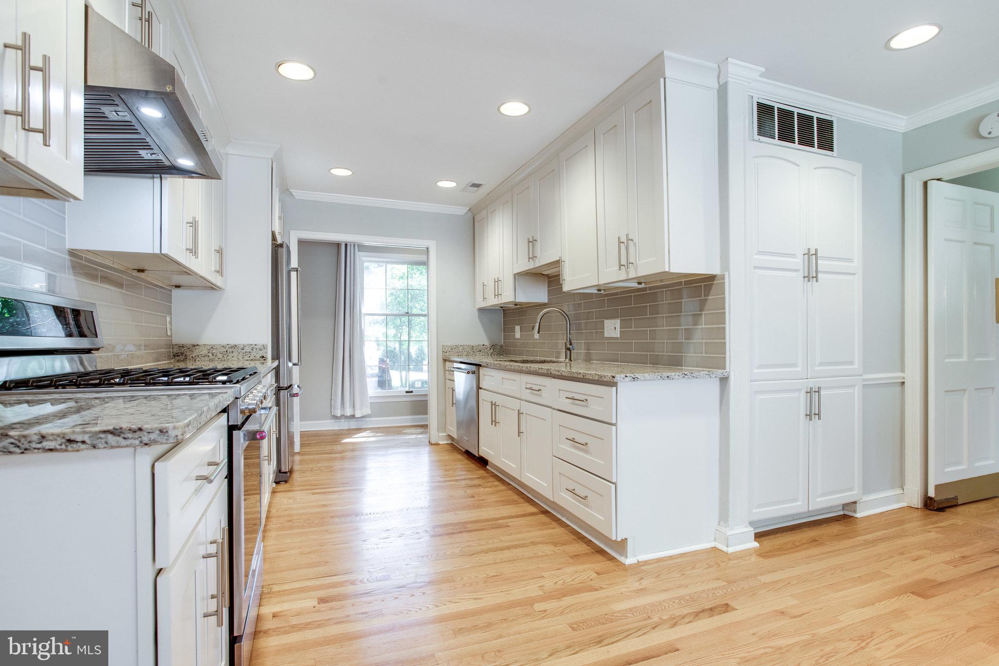 8500 Brook Road McLean, VA 22102 - Photo 17 of 59 a kitchen with stainless steel appliances granite countertop a stove and a sink