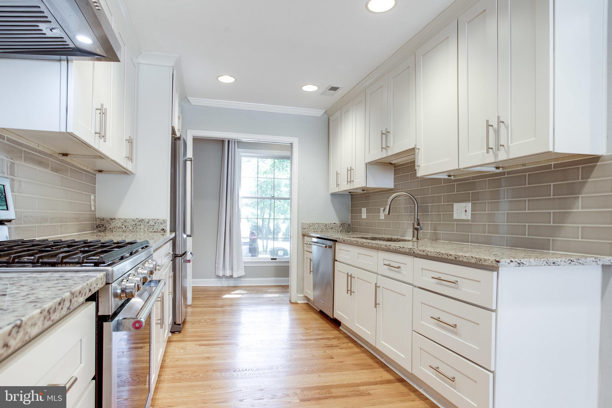 8500 Brook Road McLean, VA 22102 - Photo 18 of 59 a kitchen with stainless steel appliances granite countertop a stove and a sink