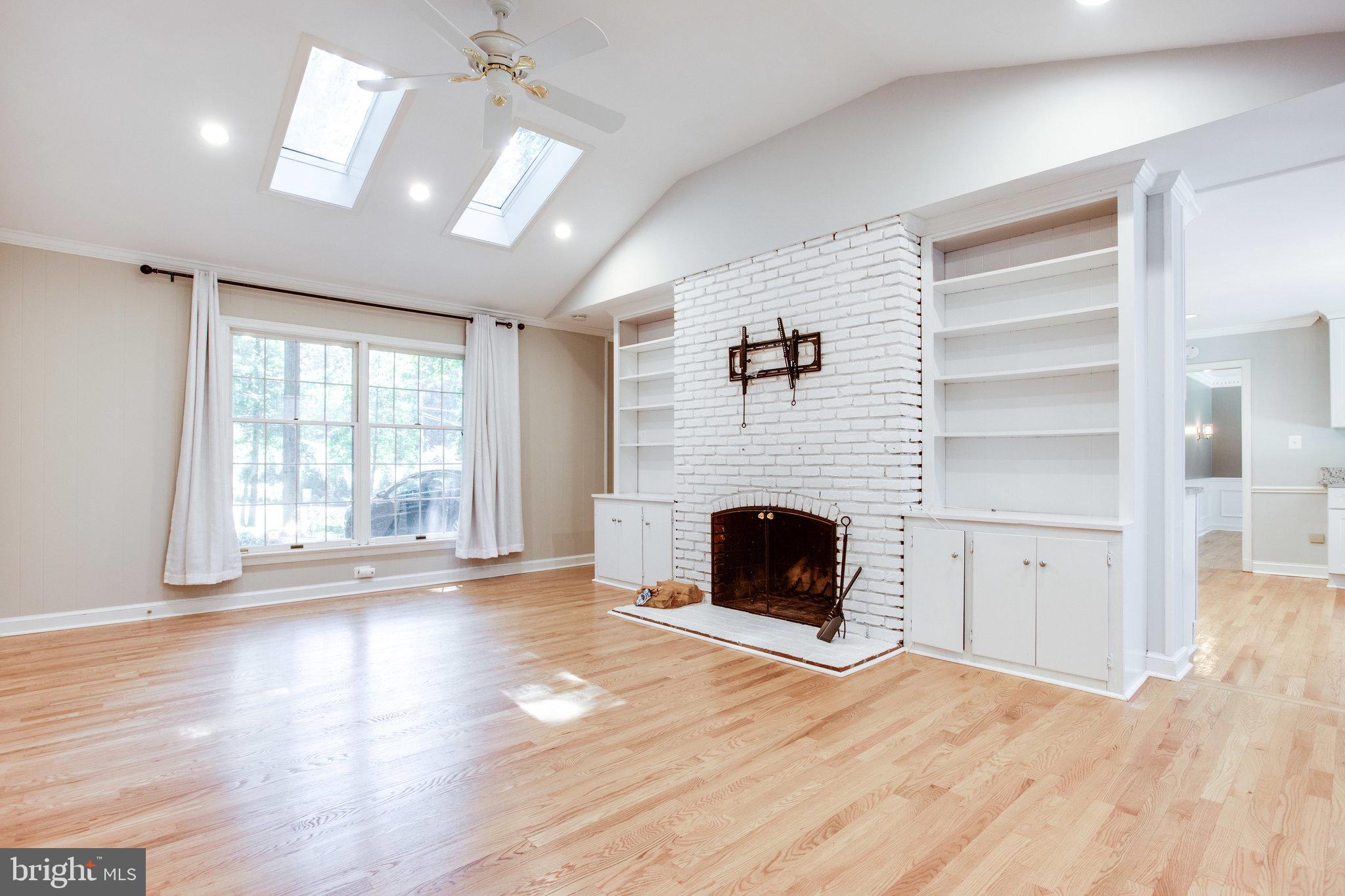8500 Brook Road McLean, VA 22102 - Photo 21 of 59 a view of an empty room with wooden floor fireplace and a window