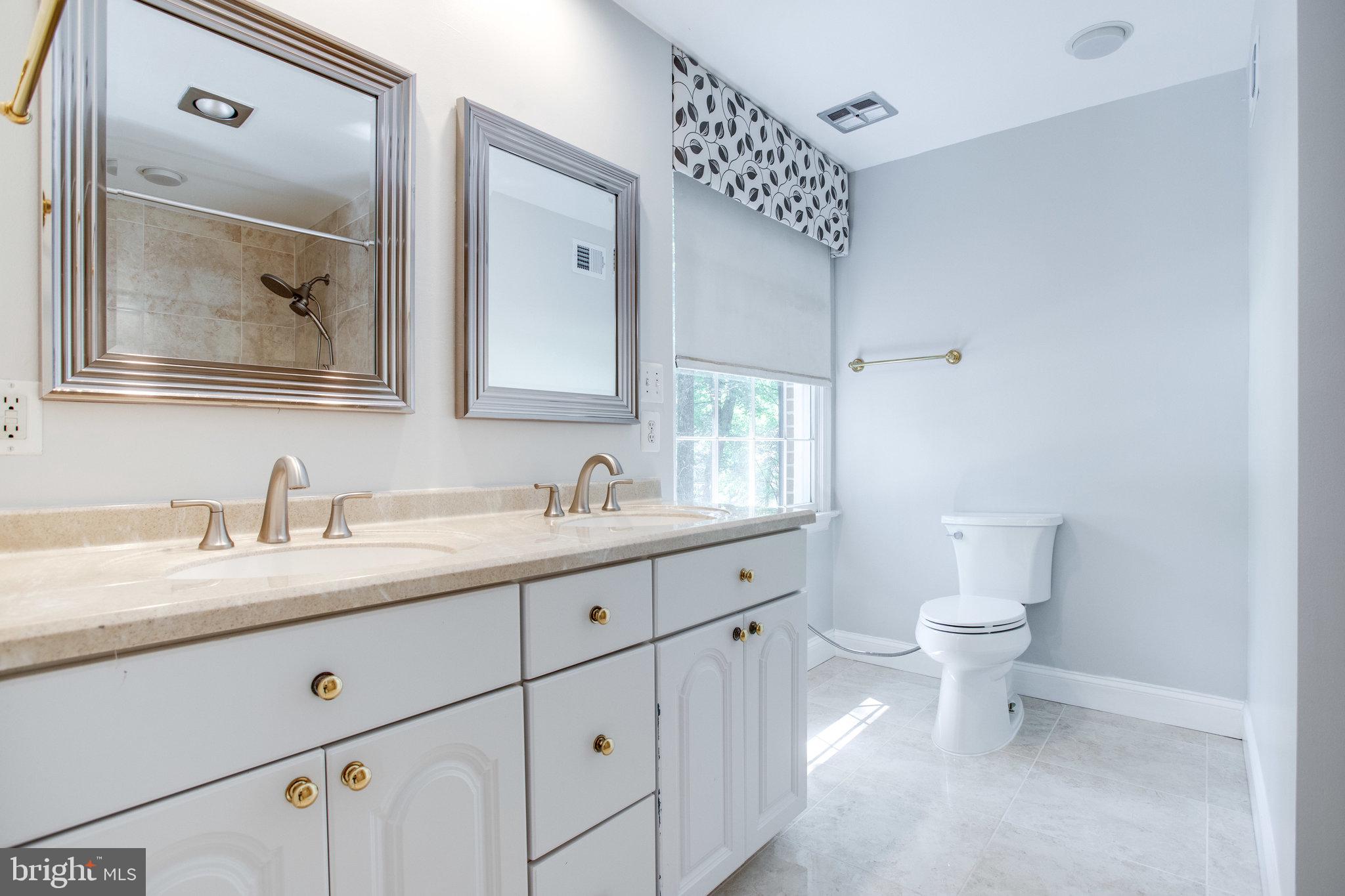 8500 Brook Road McLean, VA 22102 - Photo 36 of 59 a bathroom with a granite countertop sink mirror and toilet